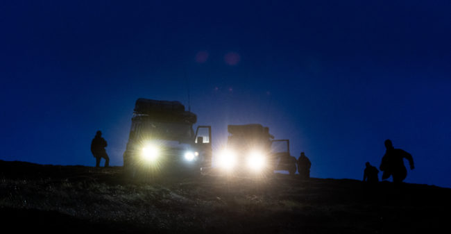 photograph of landrovers on a hill in Scotland